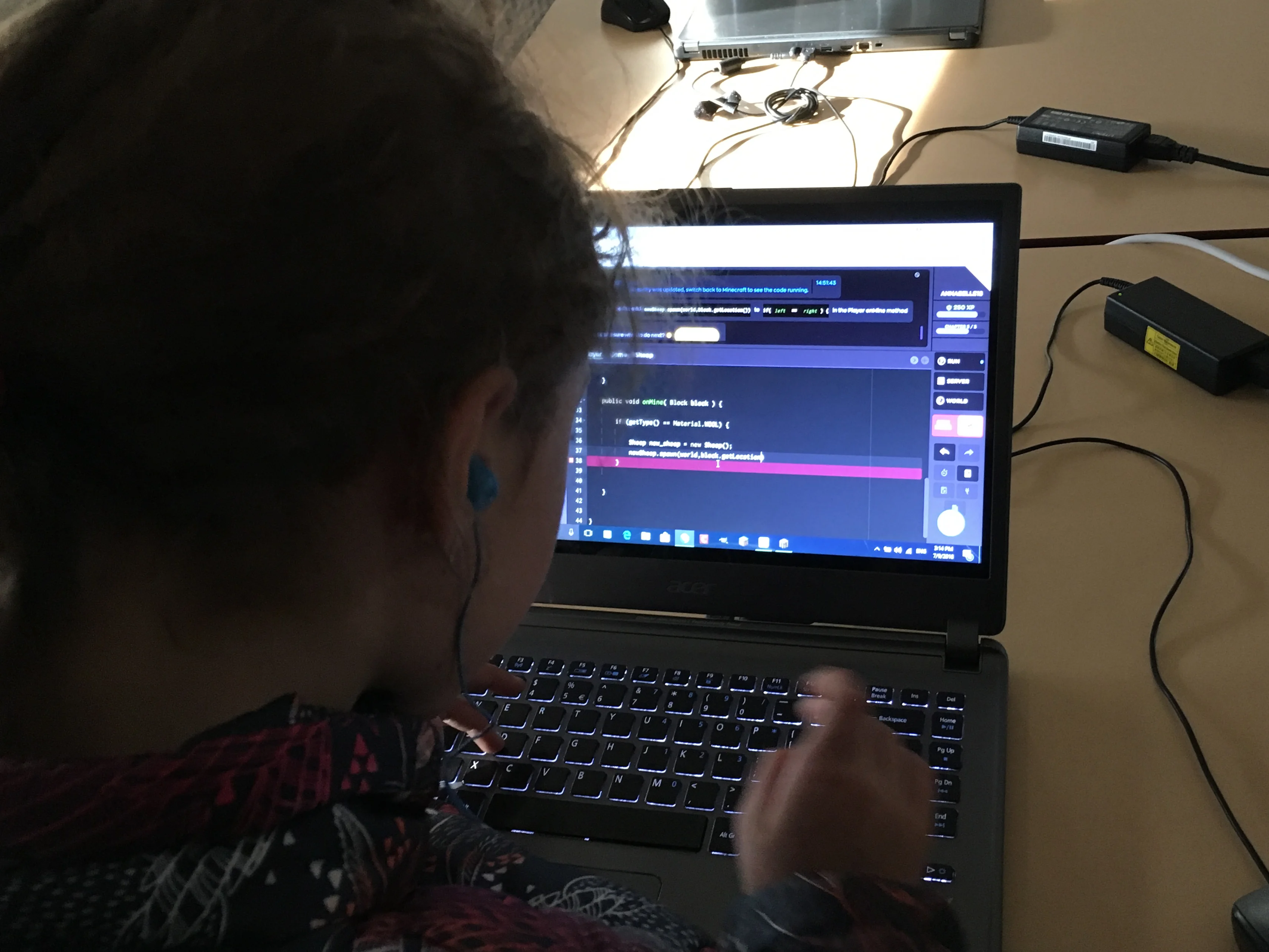Students working on computers during a Block Crafters holiday program session